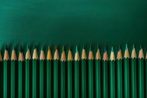 AI generated Green colorful pencils row on emerald background. Generate ai photo