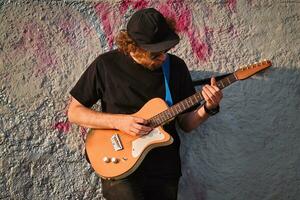 Street musician playing electric guitar in the street photo