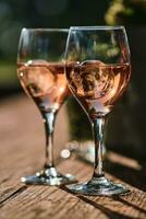 Two glasses of rose wine with ice cubes photo