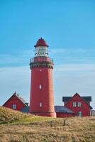 Red lighthouse at the danish coast called Bovbjerg Fyr photo