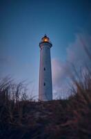 Lighthouse in the early morning hours in summer photo