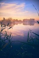 Calm lake at colorful sunrise photo