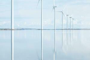 Windmills reflecting in danish Fjord photo