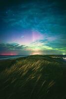 Northern lights over the dunes of denmark photo