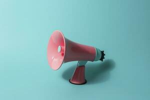 AI generated A pink megaphone on a blue background created with generative AI technology photo