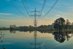 Power line reflection in lake photo