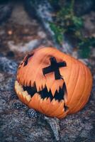 Broken Jack O Lantern on the ground photo