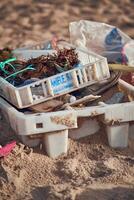 Littered trash at sand beach photo