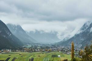 Village in a valley in Austria on overcast day photo