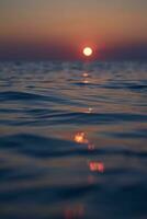 Setting sun reflecting in north sea water photo