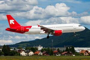 Salzburg, Austria, 2013 - Air Malta passenger plane at airport. Schedule flight travel. Aviation and aircraft. Air transport. Global international transportation. Fly and flying. photo