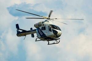 Siofok, Hungary, 2018 - Government police helicopter at airport and airfield. Rotorcraft. General aviation industry. Police utility transportation. Air transport. Fly and flying. photo