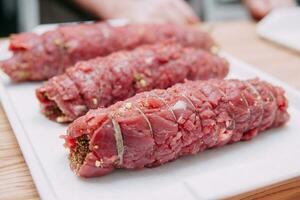 Cooking meat rolls in a cooking class. The beef roll. Raw meat, close-up. photo