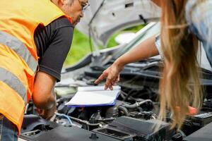 Closeup and crop motor vehicle mechanic checking engine according to customer orders on blurred background. photo