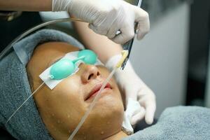 Closeup hands of beauty doctor is preparing the face for skin lightening and maintain the skin condition of the customers. photo