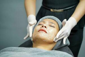 Closeup beauty woman making face spa and facial mask. photo