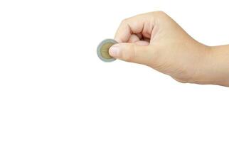 Child or kid hand holding coin isolated with clipping path Concept of saving money for the future or money growth photo