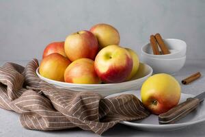 Beautiful ripe apples on a plate with a knife and a napkin. Selective focus. photo