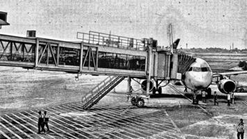 Kuala Lumpur, Malaysia on May 2023. Illustration of an airplane apron where passengers board the plane using an aerobridge. photo