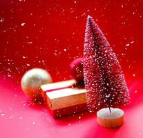 christmas tree and gifts on bright red background photo