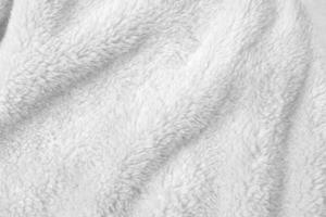 White clean wool texture background. light natural sheep wool. white seamless cotton. texture of fluffy fur for designers. close-up fragment white wool carpet. photo