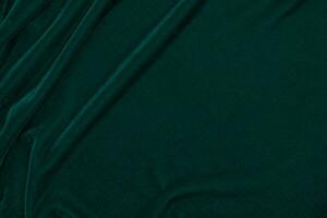 Green velvet fabric texture used as background. Empty green fabric background of soft and smooth textile material. There is space for text. photo