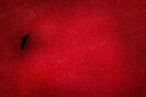 Textured red suede background. Macro photo of suede.