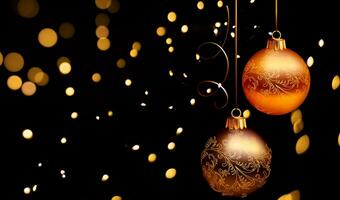 Golden Christmas ornaments on black background with bokeh lights photo