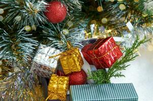 Christmas composition with Christmas tree branches, red tinsel, gift boxes and silver tinsel photo