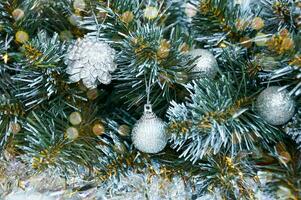 Christmas background with Christmas tree branches, silver layers and silver tinsel. Christmas decorations photo
