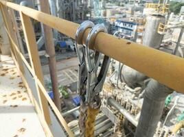 The hook harness must be attached when working at heights in the construction area to make it safer photo