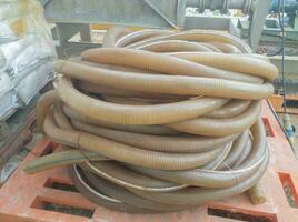 a large pile of hoses that are often used to suck up water in large discharges photo