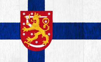 Flag and coat of arms of Republic of Finland on a textured background. Concept collage. photo