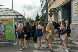 Nitra, Slovakia - 05.19.2023 Beautiful school graduates have fun and rejoice and walk along the city streets. photo