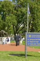 Naval College, Annapolis, MD, USA 2023. People at the statue behind the info signpost on campus at the United States Naval Academy at Annapolis MD photo