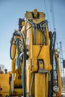 Part of modern yellow excavator machines. Vertical view photo