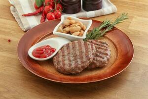 Grilled beef burger cutlet with sauce photo