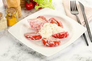 Salad with sliced tomato and stracciatella photo