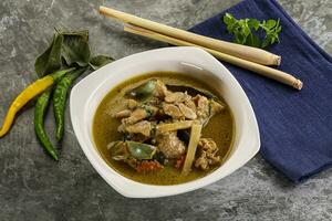 Thai green curry soup with basil photo