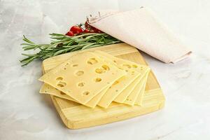 Sliced maasdam cheese with holes photo