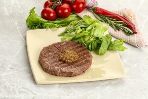 Frilled beef burger cutlet with iceberg photo