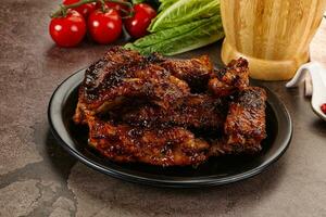 Grilled pork ribs in barbecue sauce photo