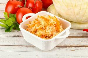 Fermented cabbage sauerkraut in the bowl photo
