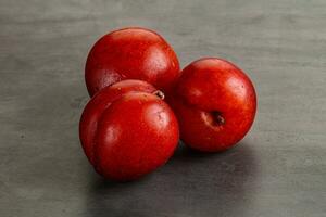 Ripe sweet juicy red plum photo