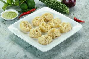 Nepali steamed dumplings  Momo with sause photo