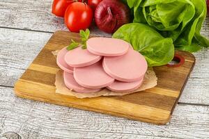 Slices boiled sausages for breakfast photo