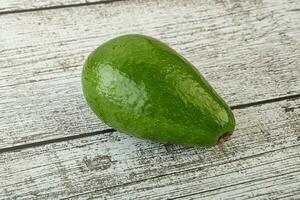 Ripe green avocado over background photo