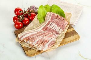 Sliced pork bacon oved board photo