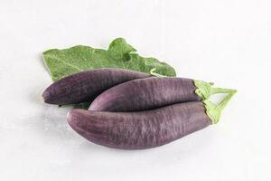 Raw ripe organic eggplant with leaf photo