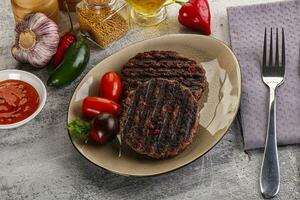 Grilled burger cutlet with sauce photo